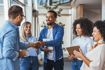 Diverse Team Celebrating Success with a Handshake Meeting
