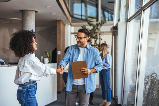 Friendly Business Meeting With Handshake in Modern Office