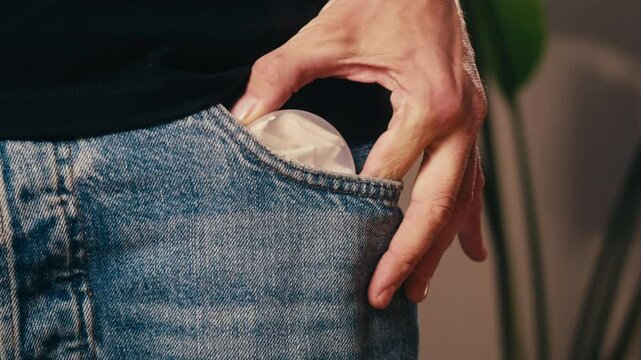Snus nicotine tobacco close up, pack of tobacco for gum. unhealthy addiction. Man opening box with snus and taking one. 