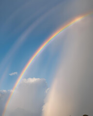 bright rainbow, rainbow in the sky, rainbow in blue sky, colorful rainbow, vibrant rainbow, blue sky with rainbow, rainbow arching, rainbow after rain, sky with rainbow, colorful arc in the sky, brigh