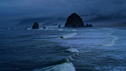 Rushing ocean waves on beautiful Oregon coast with rain storm
