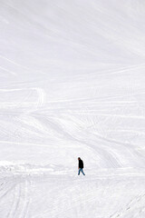 lonely man walking on snow covered caucasus mountain at georgia gudauri