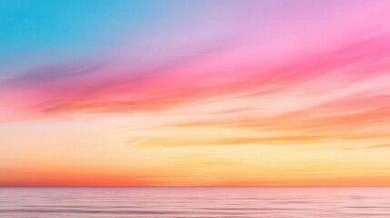 Obraz premium Vibrant sunset with pink and orange hues over a calm ocean, peaceful and dreamy