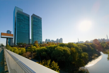 Fototapeta premium Autumnal urban river view on Sunday morning, with sunlight, in Yeouido Saetgang Ecological Park, in Seoul, Korea 