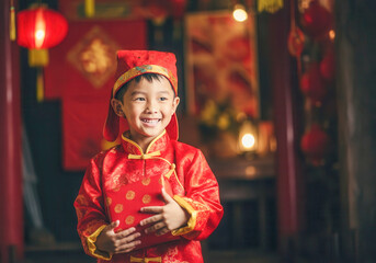 Joyful celebration: child in festive red attire embracing the lunar new year tradition