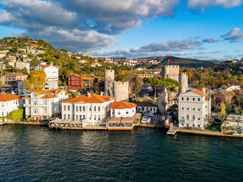 Aerial view of anatolian fortress overlooking the bosphorus with scenic hills and urban buildings, Anadolu Hisari, Turkey.