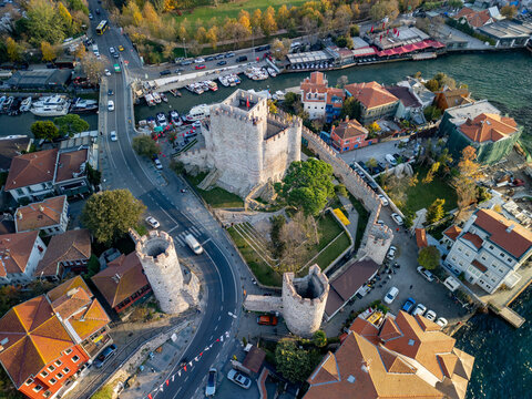 Aerial view of the beautiful medieval Anadolu Hisari fortress along the Bosphorus river with scenic greenery, Istanbul, Turkey.