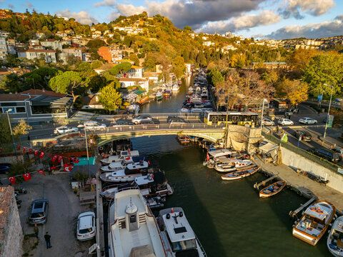 Aerial view of Goksu Creek with beautiful boats and a scenic bridge surrounded by vibrant greenery and homes, Anadolu Hisari, Istanbul, Turkey.