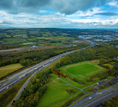 Aerial view of the iconic angel of the north surrounded by scenic countryside and vibrant greenery, Birtley, United Kingdom.