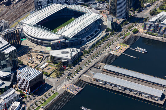 Aerial view of vibrant marvel stadium and waterfront with modern buildings and harbor, Docklands, Melbourne, Australia.