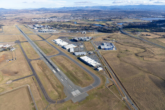 Aerial view of canberra airport with runway, buildings, fields, and roads, Pialligo, Australia.