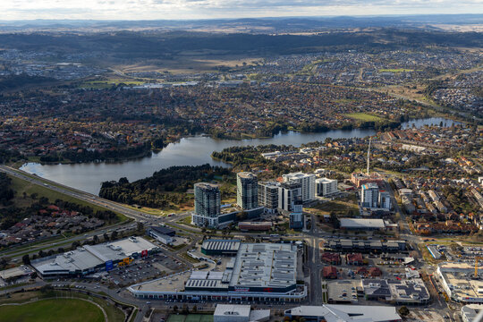 Aerial view of beautiful urban cityscape with modern buildings and serene lake, Gungahlin, Australia.
