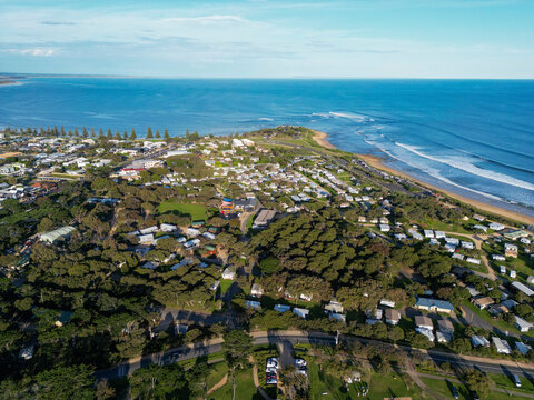Aerial view of rocky point with beautiful coastline and urban landscape, Torquay, Australia.