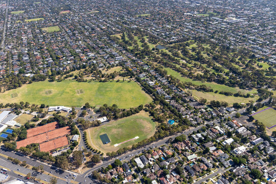 Aerial view of spacious Dendy Park surrounded by suburban houses and greenery, Brighton East, Australia.