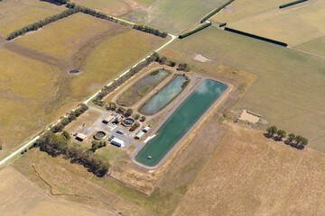 Aerial view of water treatment plant surrounded by fields and trees, Gerangamete, Australia.