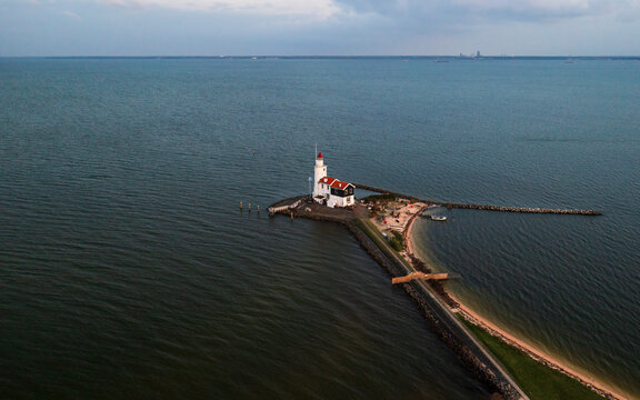 Aerial view of Paard van Marken, lighthouse at sun set along the water in the Netherlands, near Amsterdam in Marken.