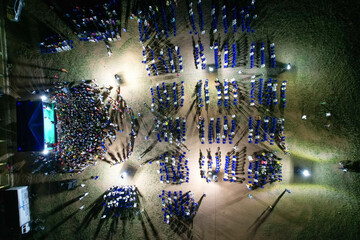 Aerial view of vibrant festival gathering with a dynamic crowd and illuminated stage, Ikole, Nigeria.