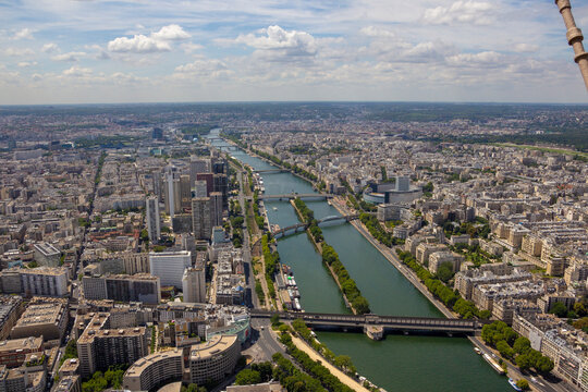 Aerial view of bustling cityscape with historic architecture and the Seine River, Paris, France.