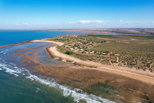 Aerial view of beautiful sandy beach and tranquil ocean waves at Point Samson foreshore, Point Samson Community Park, Western Australia.
