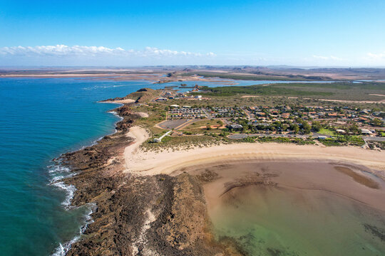 Aerial view of beautiful Honeymoon Cove Beach with sandy shoreline and calm ocean, Point Samson, Australia.
