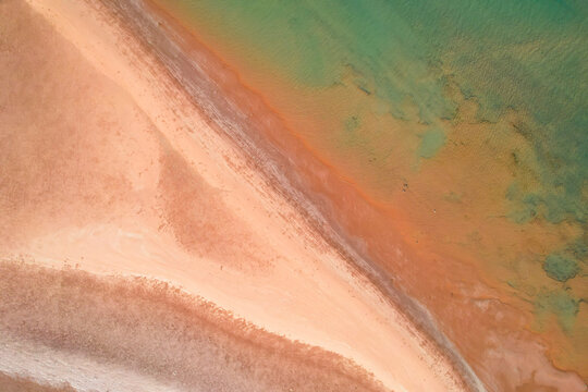 Aerial view of the serene Nullagine River with turquoise water and sandy beaches, Cossack, Australia.