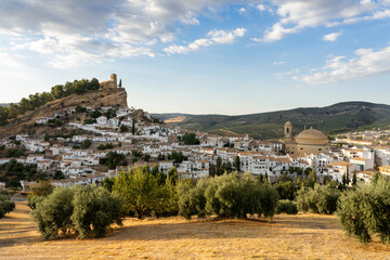 Fototapeta premium Panoramic view of Montefrio since National Geographic lookout with olive trees in the foreground at sunset. Granada, Andalucia, Spain.