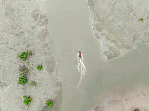 Aerial view of serene bodo river with tranquil greenery and a boat, Bonny, Nigeria.
