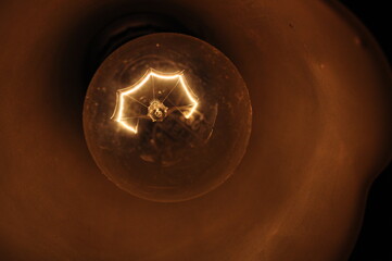 Vintage low voltage dim lightbulb in the dark