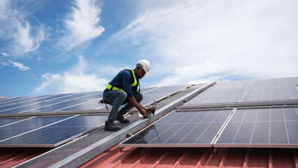 Service engineer checking solar cell on the roof for maintenance if there is a damaged part....
