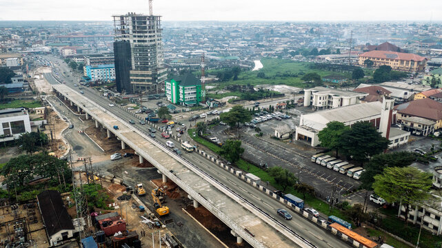 Aerial view of overpass construction with busy roads and modern buildings, Port Harcourt, Nigeria.