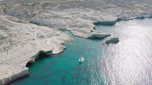 White yacht on seacoast of Greece island Milos