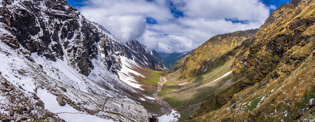 Panoramic view of glacial u-shaped valley having snow cladded peaks, glaciers and moraines  deposited by glacier enroute high altitude trek 4650m in Himachal Pradesh.