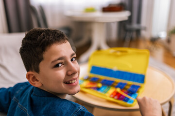Boy plays metallophone at home.