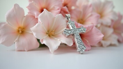 Easter cross adorned with delicate flowers in soft pastel hues, symbolizing renewal and hope in a serene setting during springtime celebrations