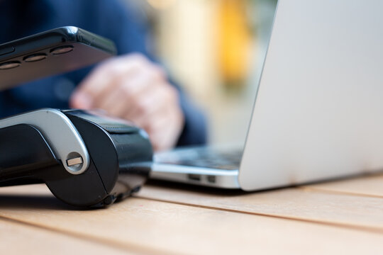 Customer paying with nfc technology on pos terminal - Powered by Adobe