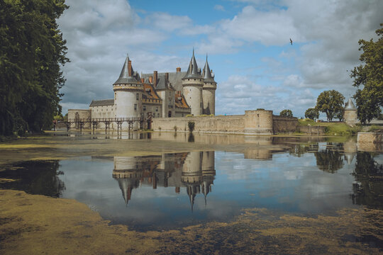 View of chateau de Sully Sur Loire with beautiful reflection in the moat, Sully-sur-Loire, France.