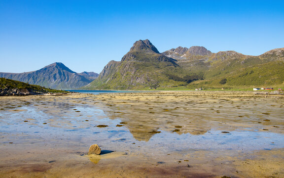 View of morpheus beach with tranquil water and majestic mountains, Flakstad, Norway.