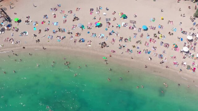 Beach scene of people relax by sea in Athens, Creece