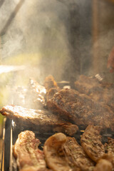 pieces of meat of various kinds are grilled on a grill where care must be taken so that they are...