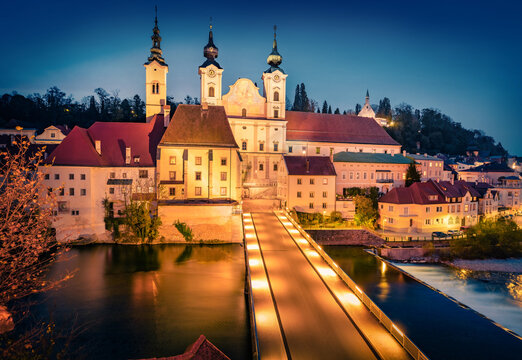Night autumn view of illuminated Catholic Church St. Michael. Beautiful evening cityscape of Steyr statutory city, located in the Austrian federal state of Upper Austria. Traveling concept background.