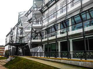 Naklejka premium Facade of a glass modern building with large panoramic windows.