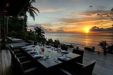 Fototapeta premium Luxurious outdoor dining area with a view of the sunset