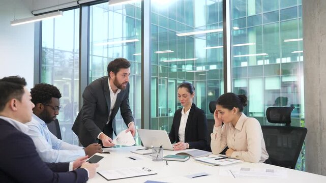 Angry boss scolding female employee for bad work result at conference Man manager CEO director yells shouts young specialist at incompetent subordinate blaming mistake in document diverse team meeting
