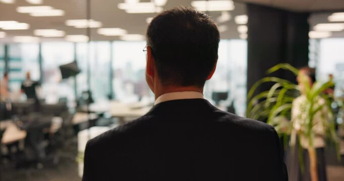 Man, business and walking with back in office for new day, morning and work ambition. Mature CEO, elevator and company floor in Japanese call center with schedule, confidence or pride for development