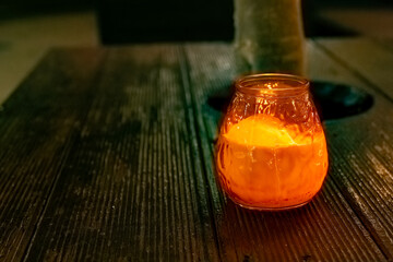 Cozy candlelight on a rustic wooden table creating a warm atmosphere in the evening
