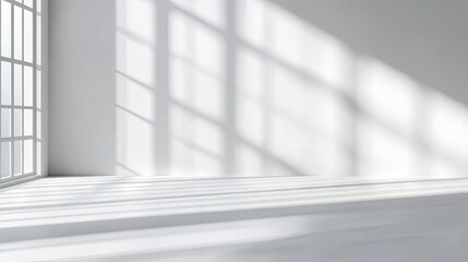 Fototapeta premium Bright, airy interior with soft shadows and light patterns on white walls and floor, creating a serene atmosphere.