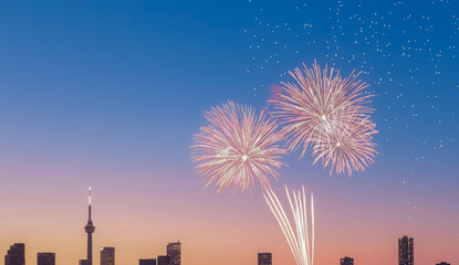 Fireworks illuminate toronto skyline at dusk