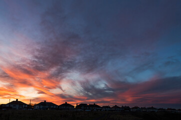 Dramatic sunset over houses with copy space