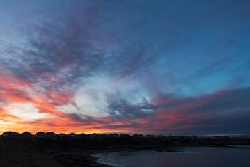Dramatic sunset over houses with copy space