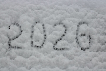 On the white snow, the numbers 2026, the concept of Christmas and New Year